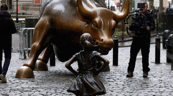 Girl staring at bull Wall Street